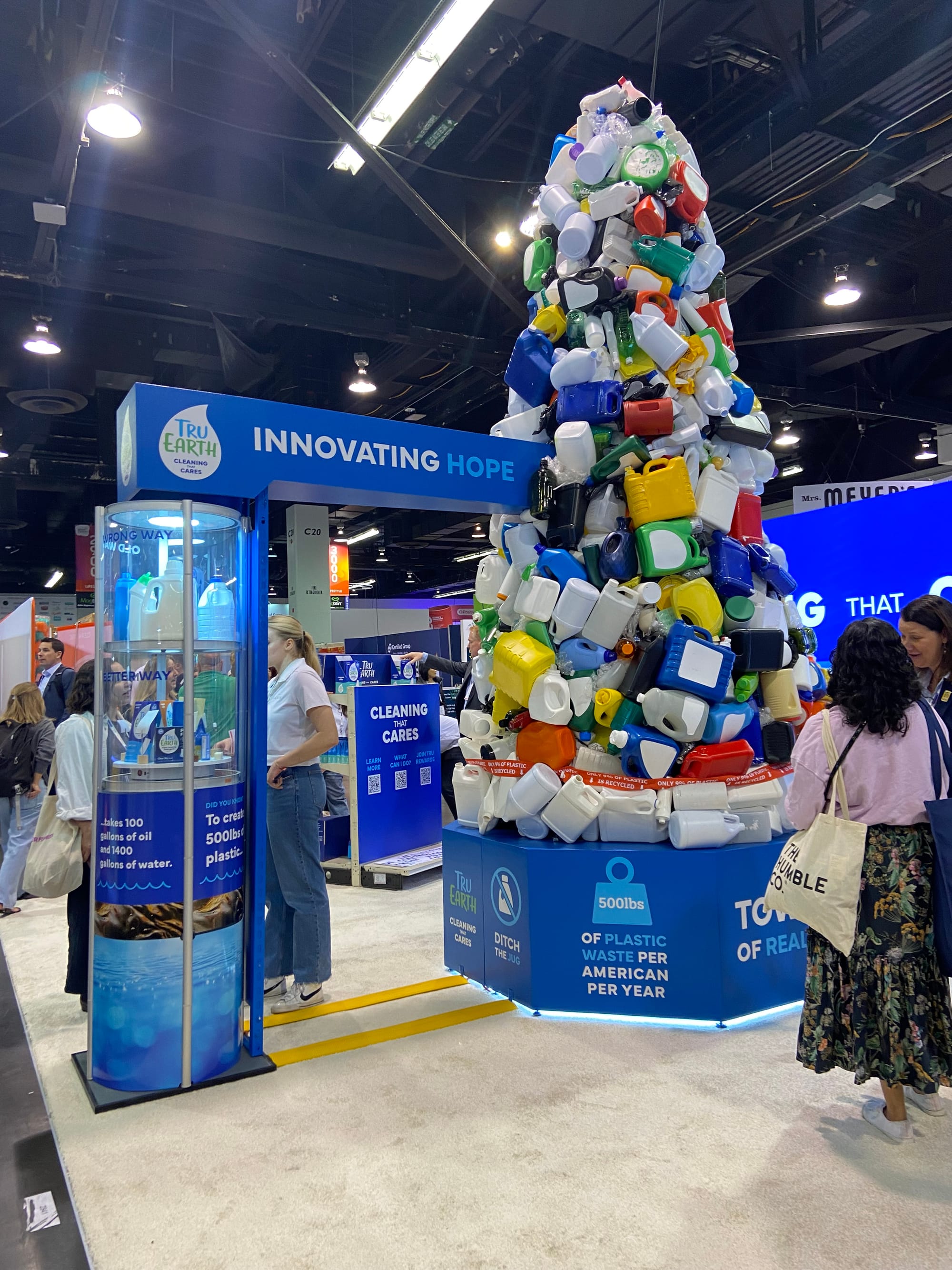 Tru Earth booth with tower of plastic jugs
