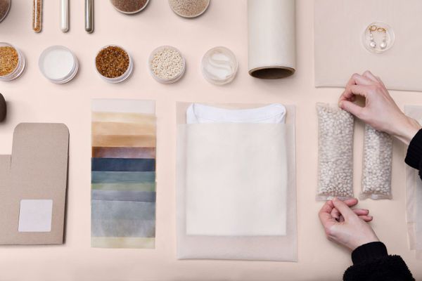A variety of plastic products with two hands holding a bag