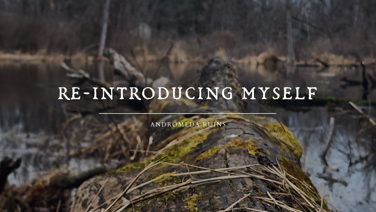 an image of a mossy log in a bog, the background is a dead woods and dry grass. there is white text over top that reads "re-introducing myself - andromeda ruins".