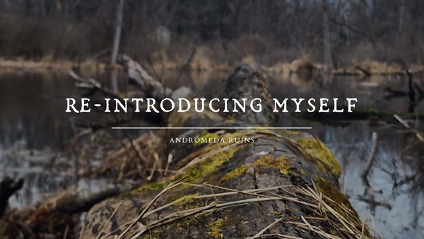 an image of a mossy log in a bog, the background is a dead woods and dry grass. there is white text over top that reads "re-introducing myself - andromeda ruins".