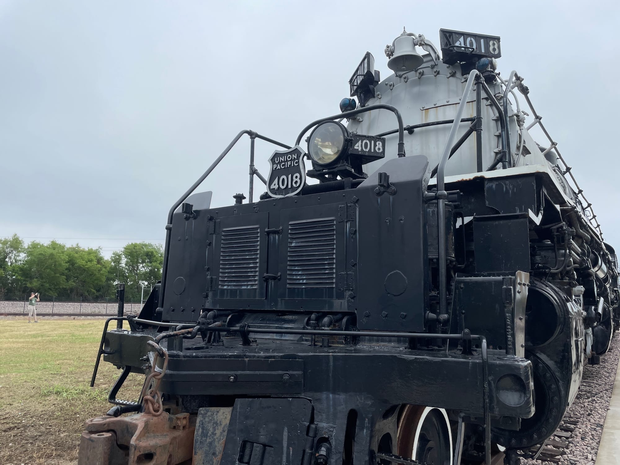 A silver and black steam locomotive. The number boards read 4018. There's a shield on the front that says Union Pacific 4018