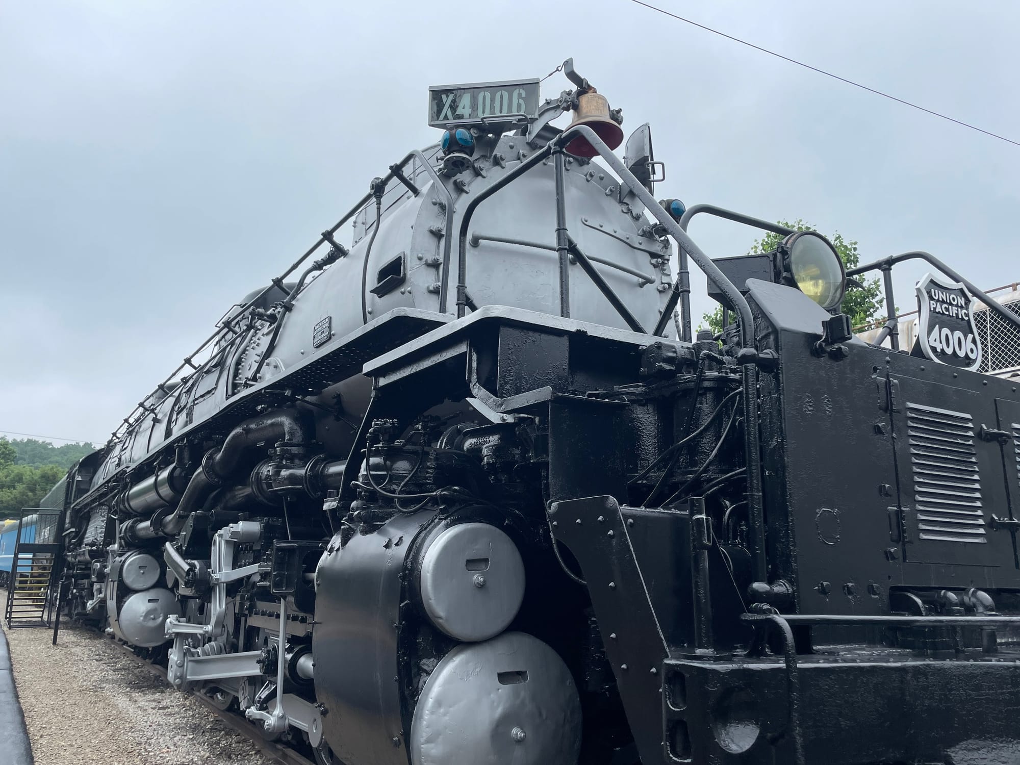 A steam locomotive with a silver boiler and black frame. Her number is x4006 and the shield on the front reads Union Pacific 4006