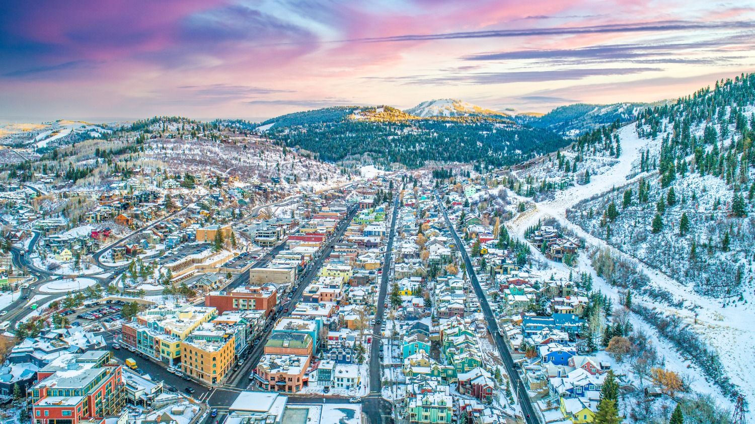 an aerial view of Park City with purple and blue skies in the evening