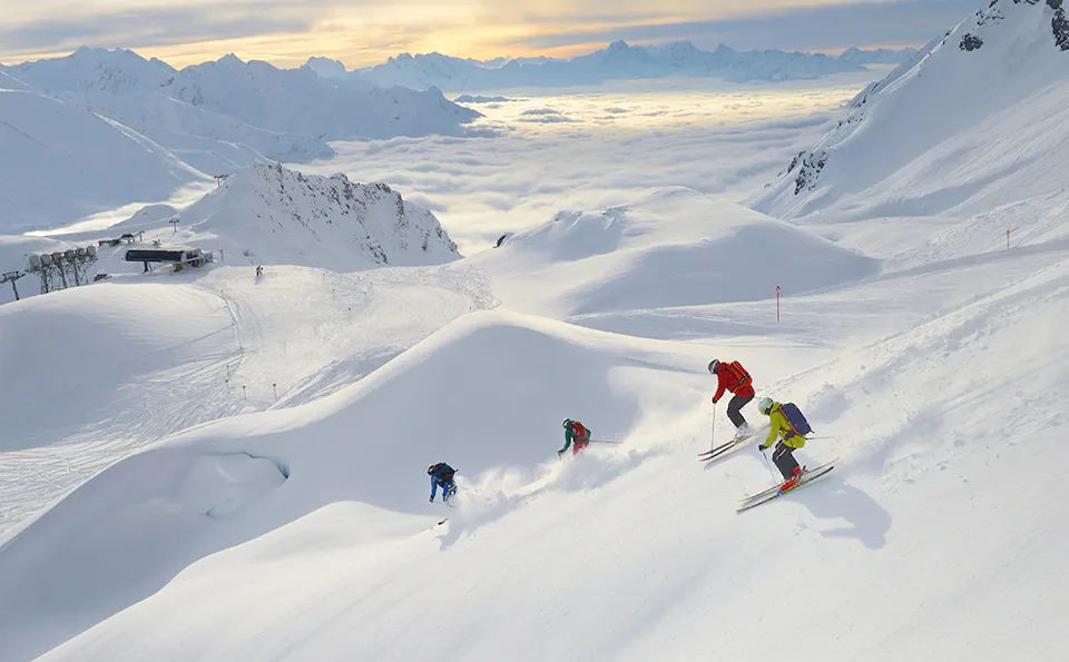 4 people skiing powder with 1st tracks at Arlberg Ski Resort