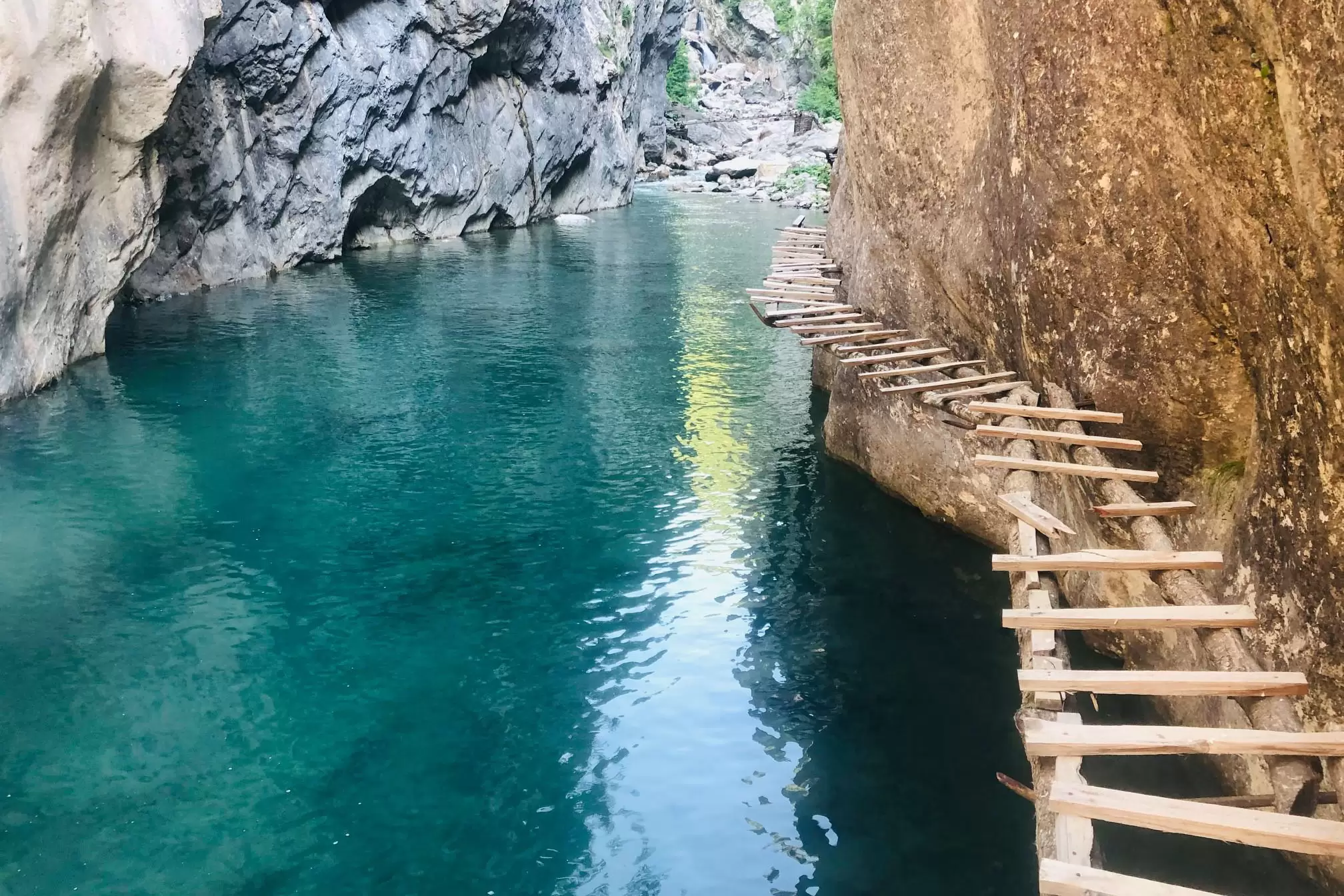 wooden walkway along the Gashi River, a beautiful clear river that is a UNESCO protected