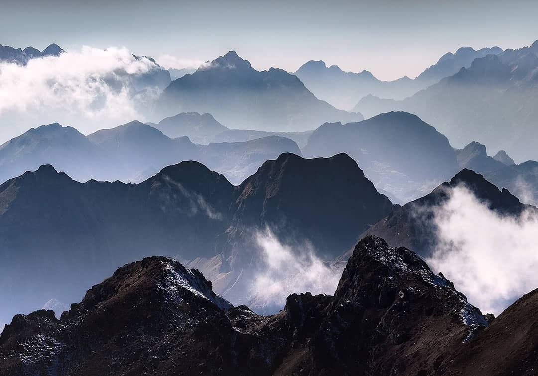 Misty view of the Accursed Mountains in northern Albania with rugged peaks and fog drifting over the dramatic alpine ridges.