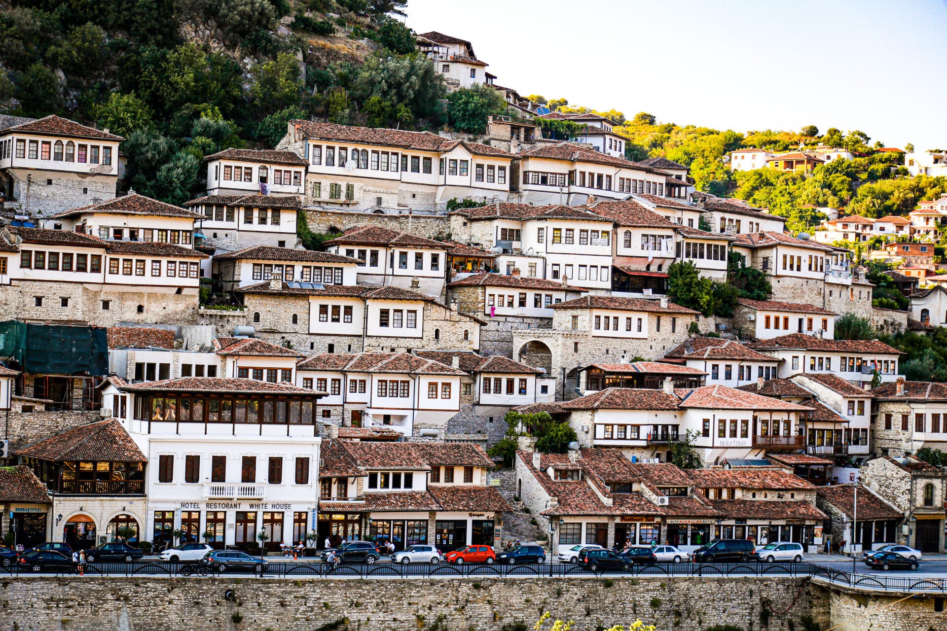 A bunch of white houses on a hillside with lots of Glass windows in Beret, Albania.
