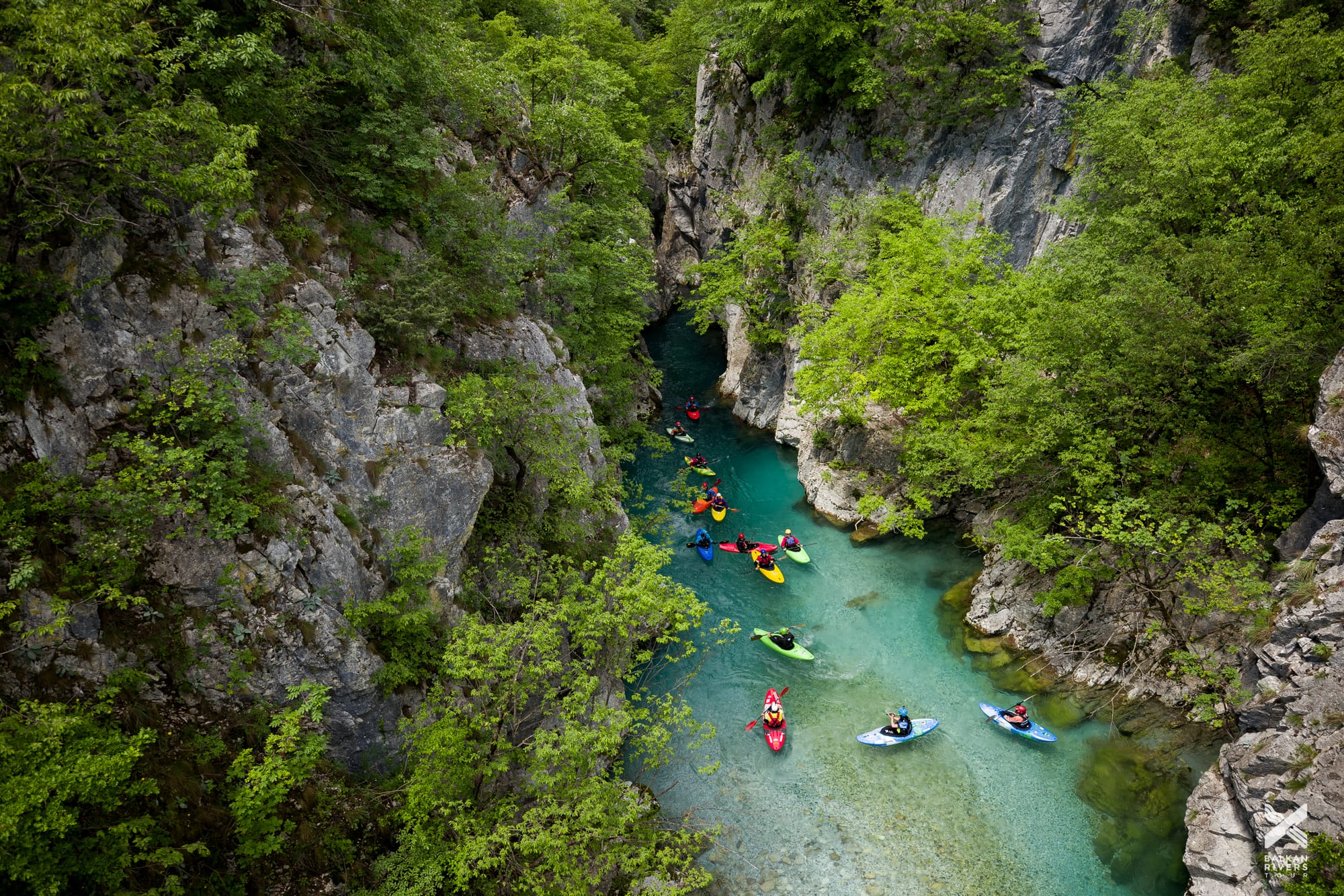 Valbona Valley National Park kayakers on the river with deep canyon and clear water