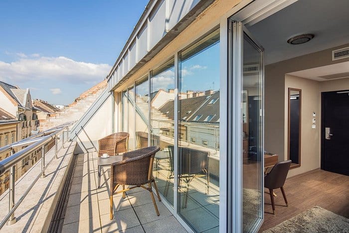 Chairs sitting on a balcony overlooking the city of Budapest from the Continental Hotel Budapest.