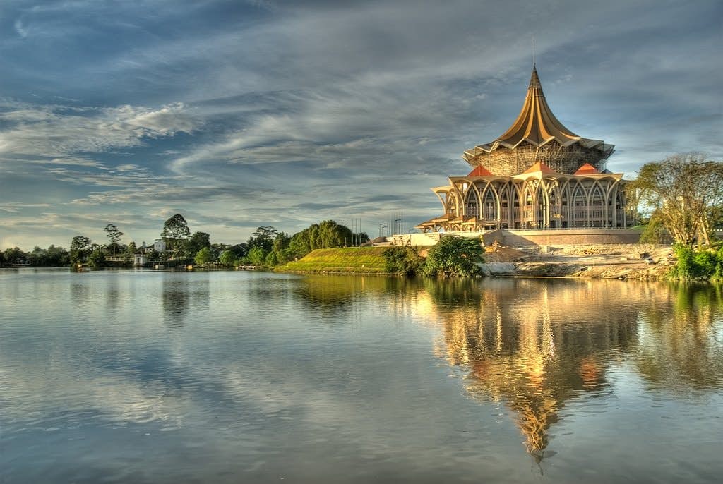 A temple at Kuching, Borneo surrounded by a lake.