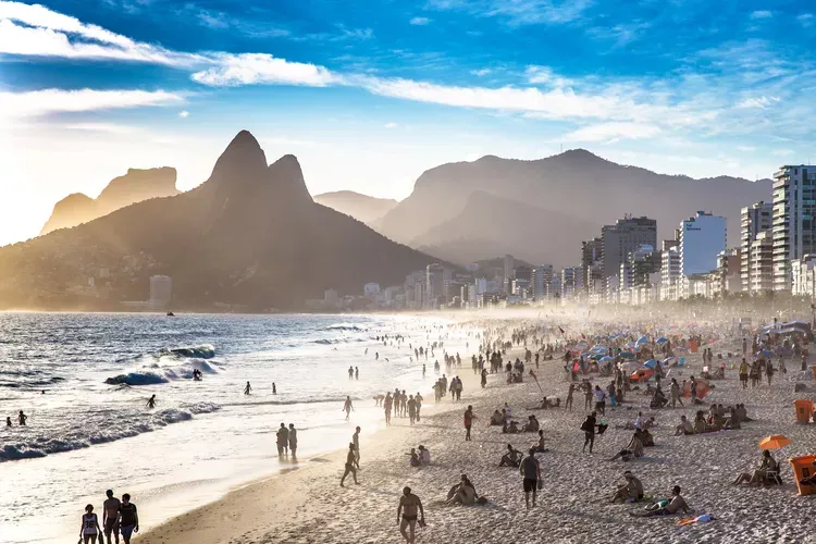 People laying out and playing in the sand at Copacabana Beach in Rio de Janeiro, Brazil.