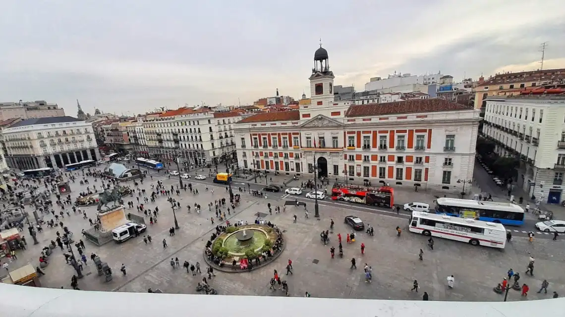Ariel view of people walking the streets and exploring Puerta del Sol in Madrid, Spain.