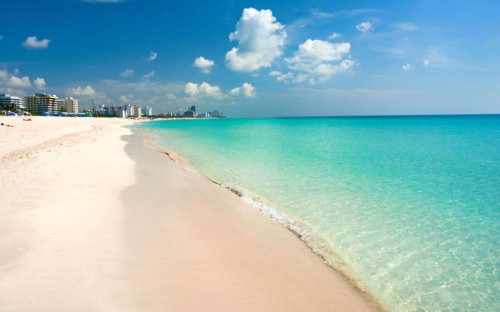Pretty white sandy beach and clear blue waters in South Beach, Miami Florida.