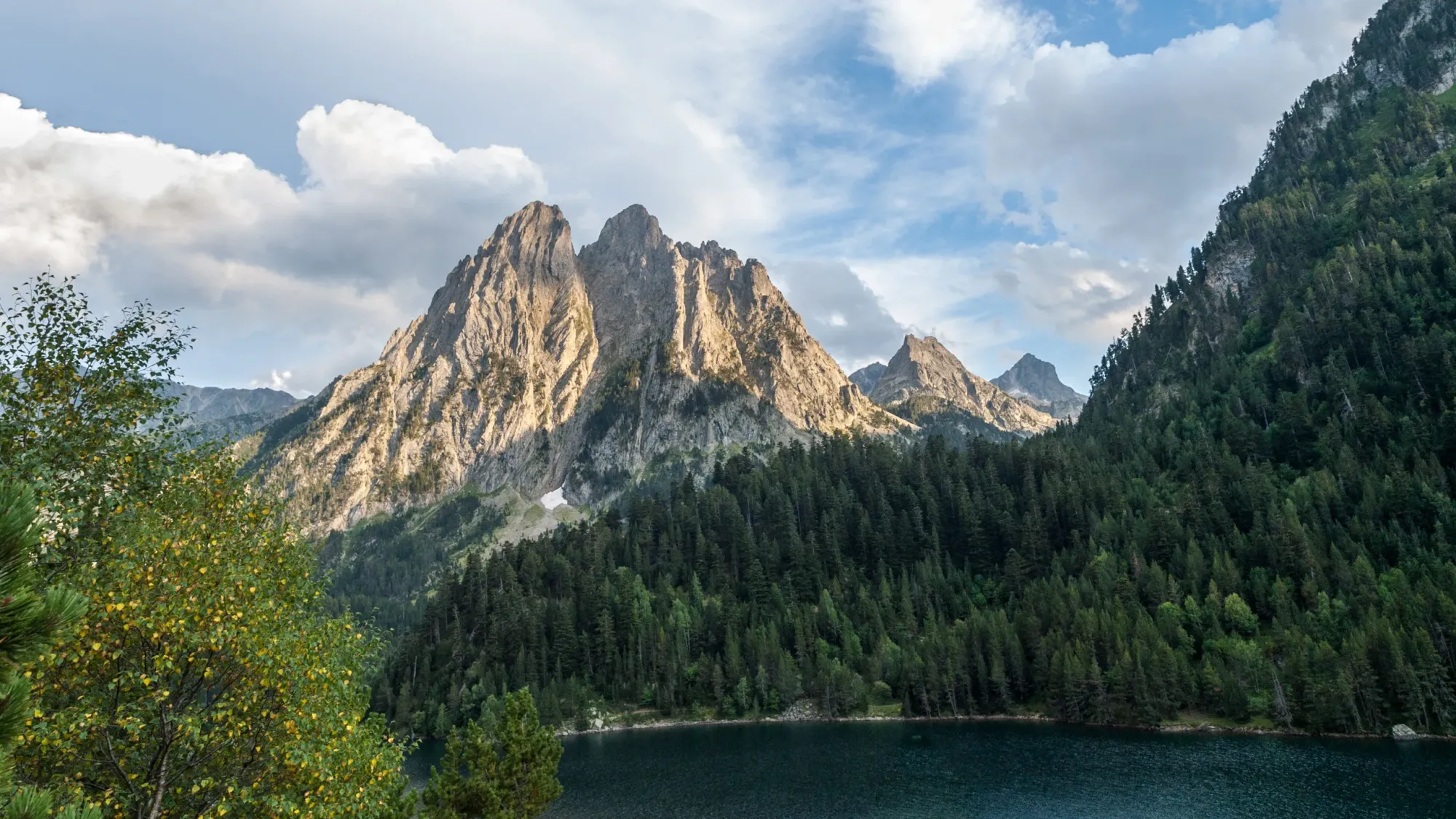 A view of a lake sitting down in the mountains at Aigüestortes i Estany de Sant Maurici National Park.