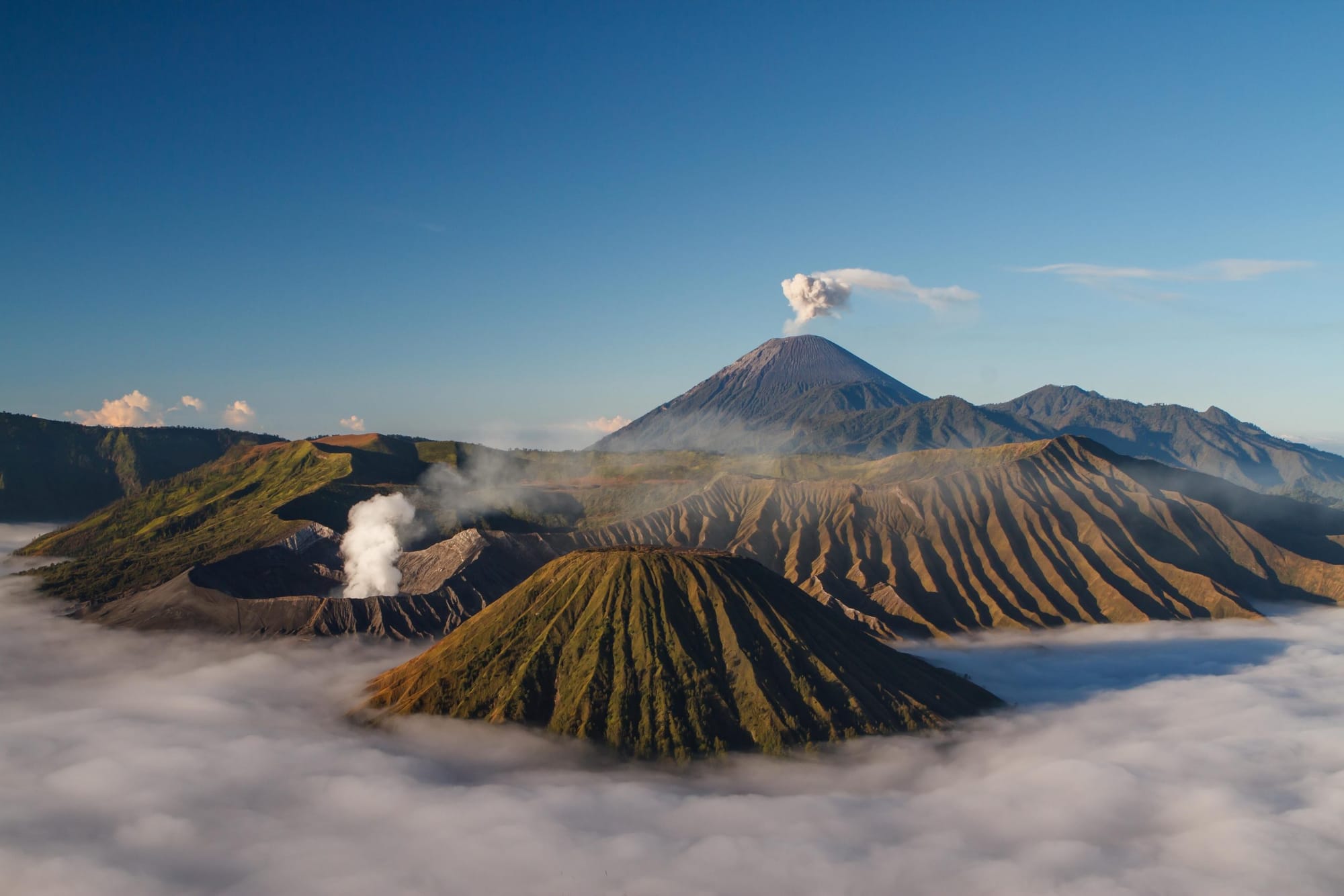 Volcanos with smoke coming out at Bromo Tengger Semeru National Park in Indonesia.