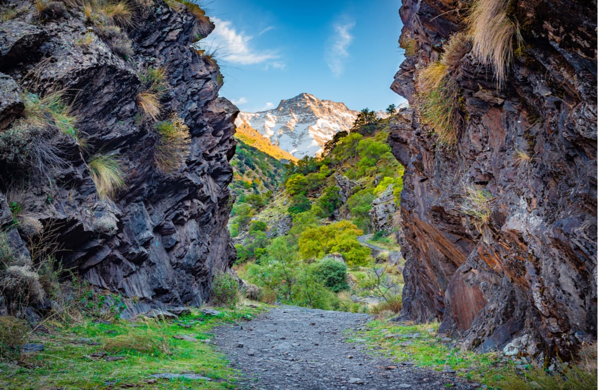A gravel path passing between two mountains at Sierra Nevada National Park.
