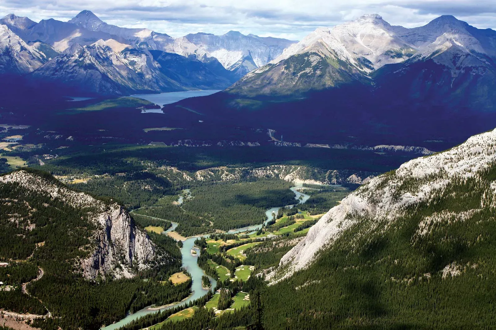 Ariel view of a river running through a valley between mountains. 