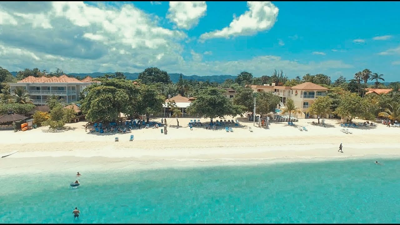 A beautiful beach and clear blue waters at Coco La Palm Seaside Resort in Negril.