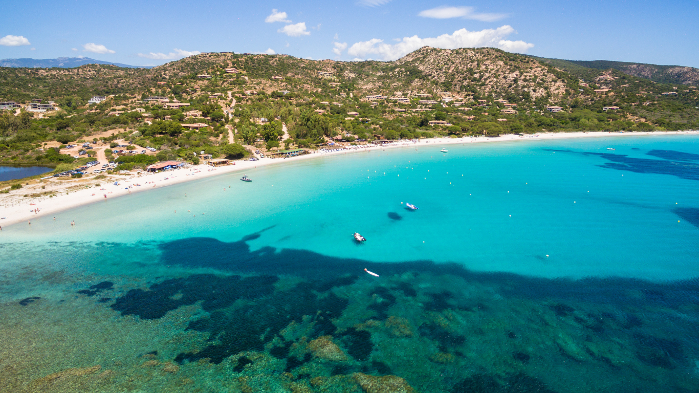 Boats anchored near Palombaggia Beach in France.