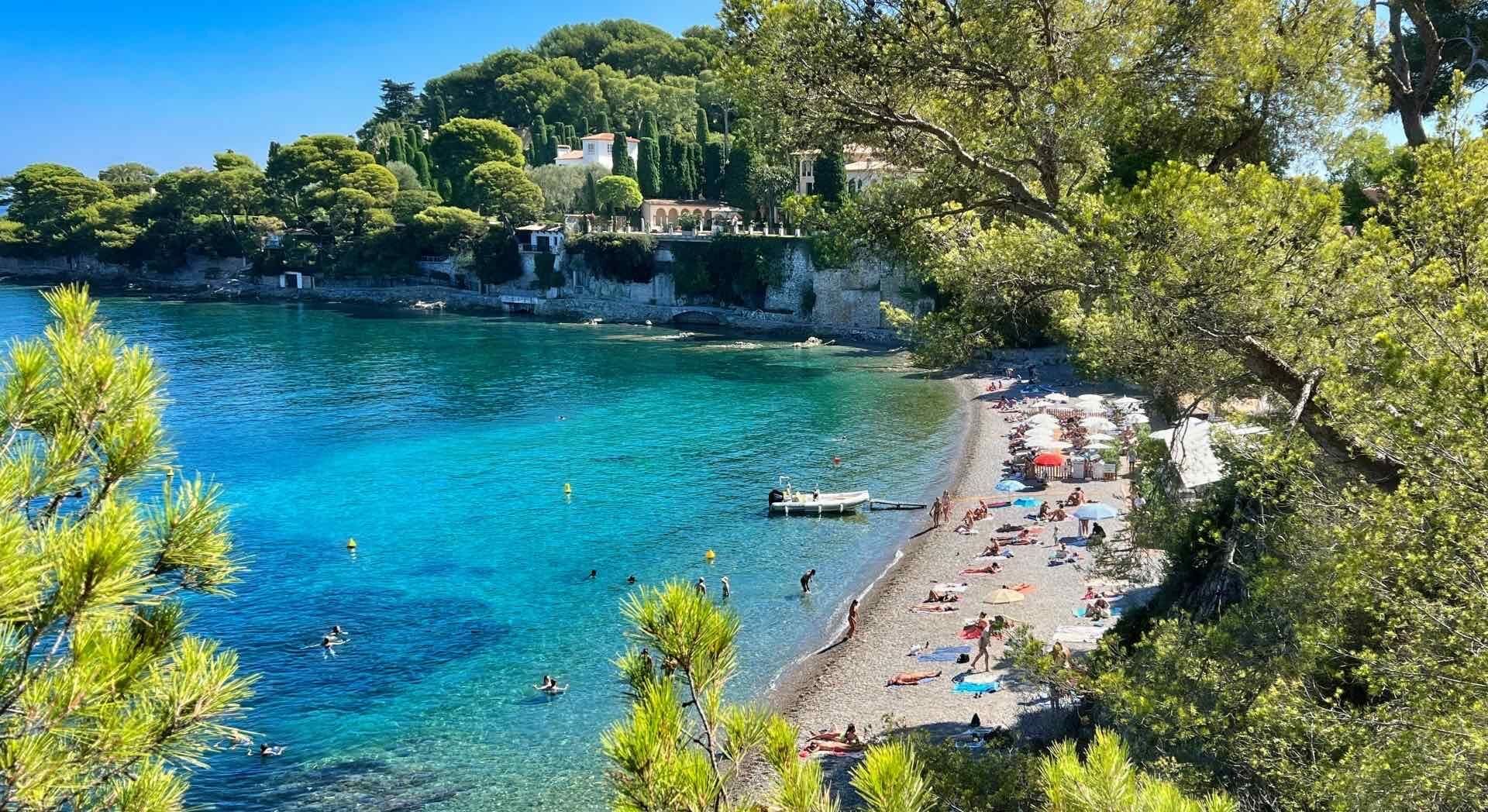 People enjoying a day at Plage de la Garoupe beach in France.