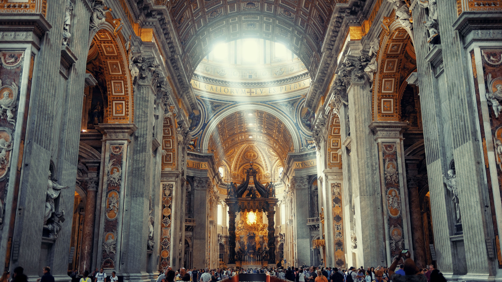People standing inside of St. Peter's Basilica In Rome.