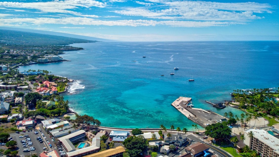 Ariel view of a port in Kona, Hawaii with beautiful clear blue waters.