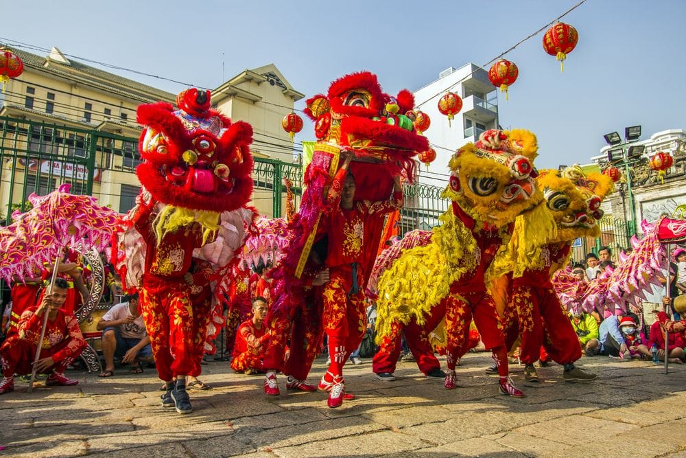 People dancing in red and yellow dragon costumes for the Chinese New Year celebrations in Hong Kong.