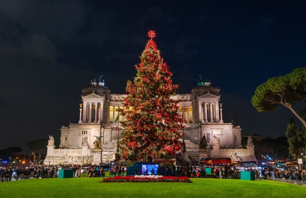 People near a large Christmas tree in Rome. 