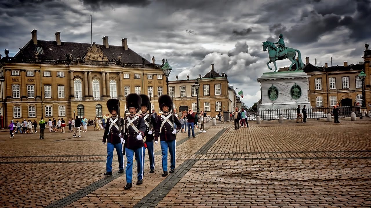 Soldiers marching on the cobble stone streets in front of Amalienborg Palace in Copenhagen, Denmark.