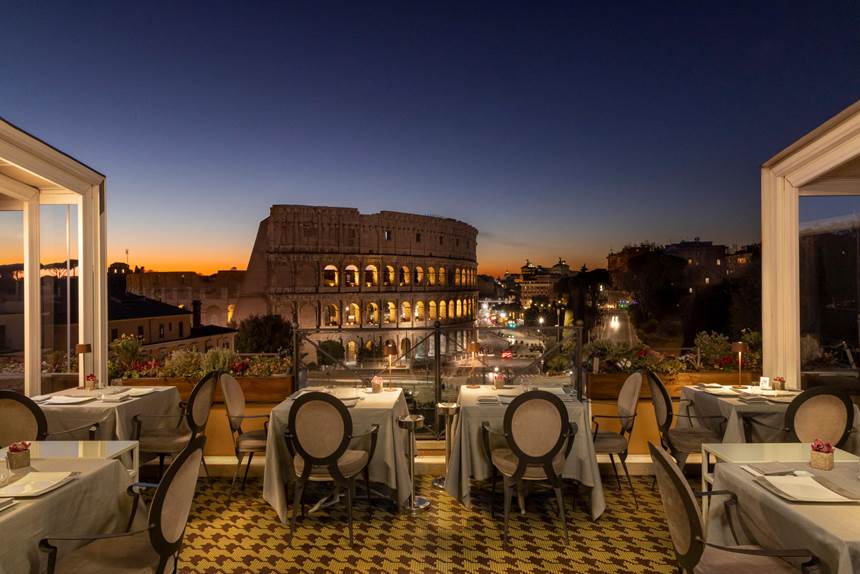Dining table set up for guest at a nice outdoor restaurant in Rome. 