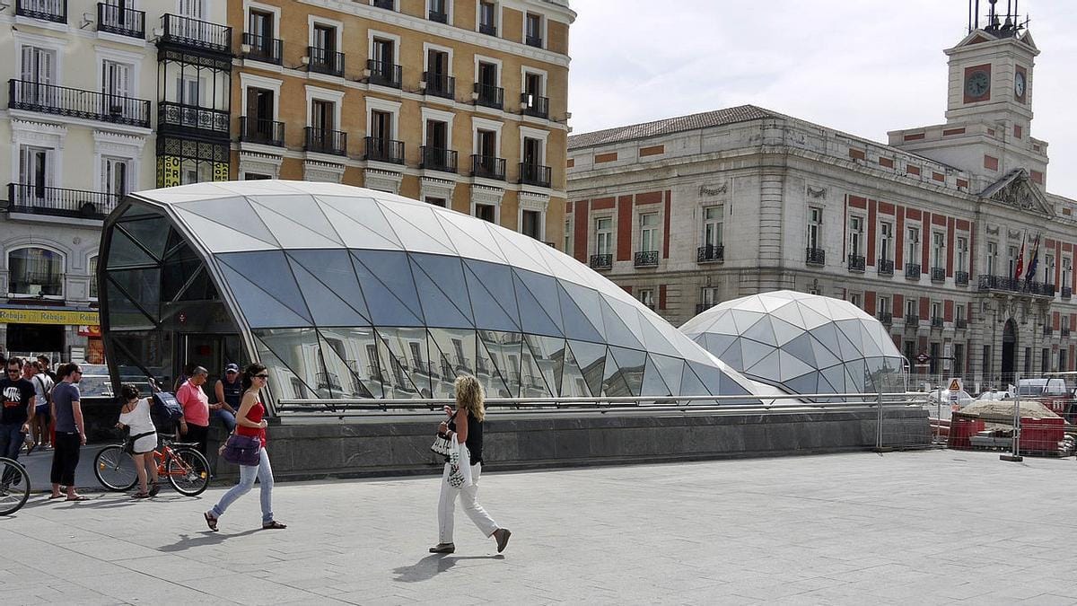 People entering a glass dome shaped tunnel to enter Puerta del Sol station in Madrid, Spain.