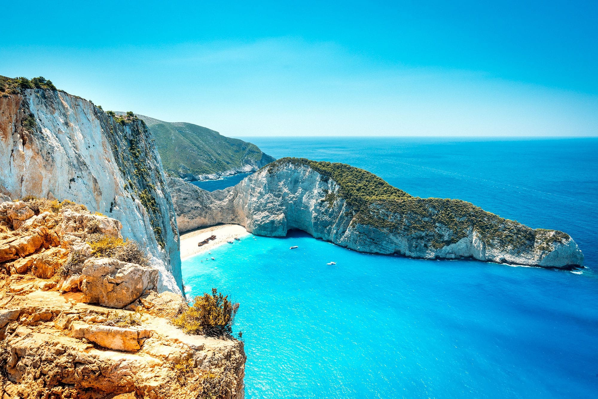 Aerial view of Navagio Beach, also known as Shipwreck Beach, on Zakynthos Island in Greece, with turquoise waters, dramatic limestone cliffs, and a famous shipwreck resting on the white sand