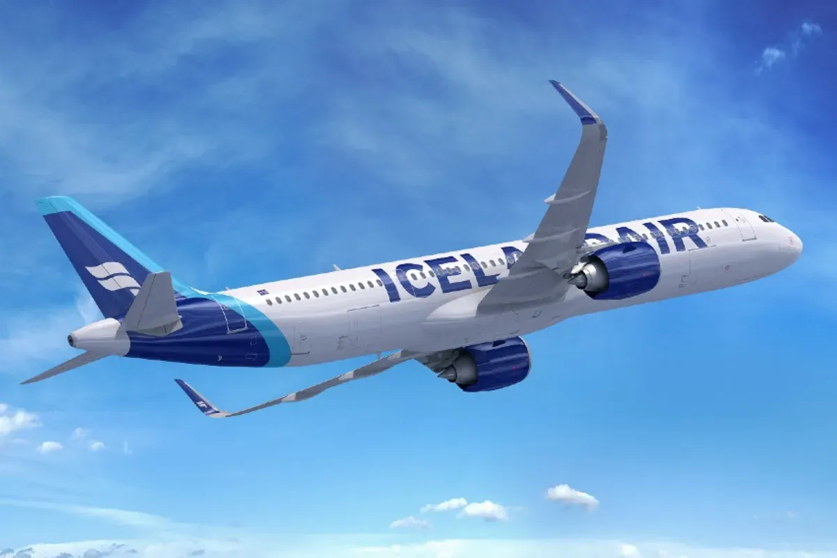 A blue and white plane with the words Icelandair on the side of it turning towards its destination route after take off.