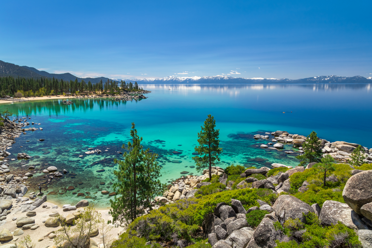 Vibrant turquoise water and granite boulders along the shore of gorgeous Lake Tahoe.