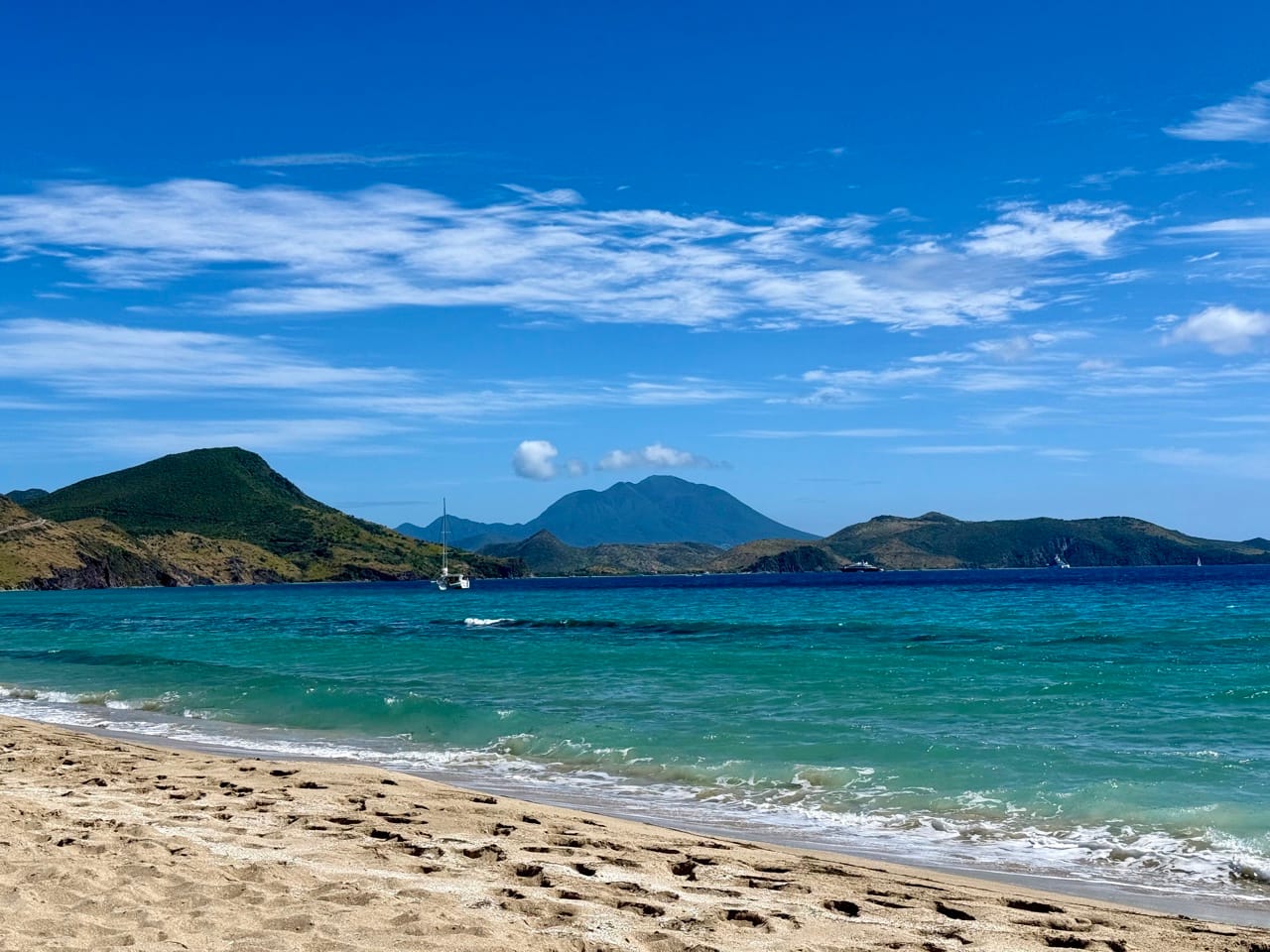 Frigate Bay South Beach in St. Kitts with mountains in the background.