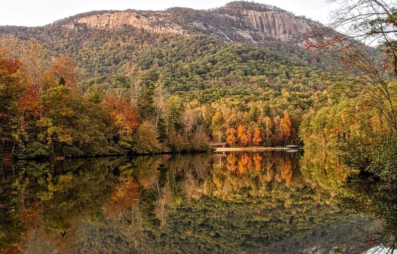 Autumn leaves reflecting on a still lake in Branson, Missouri.
