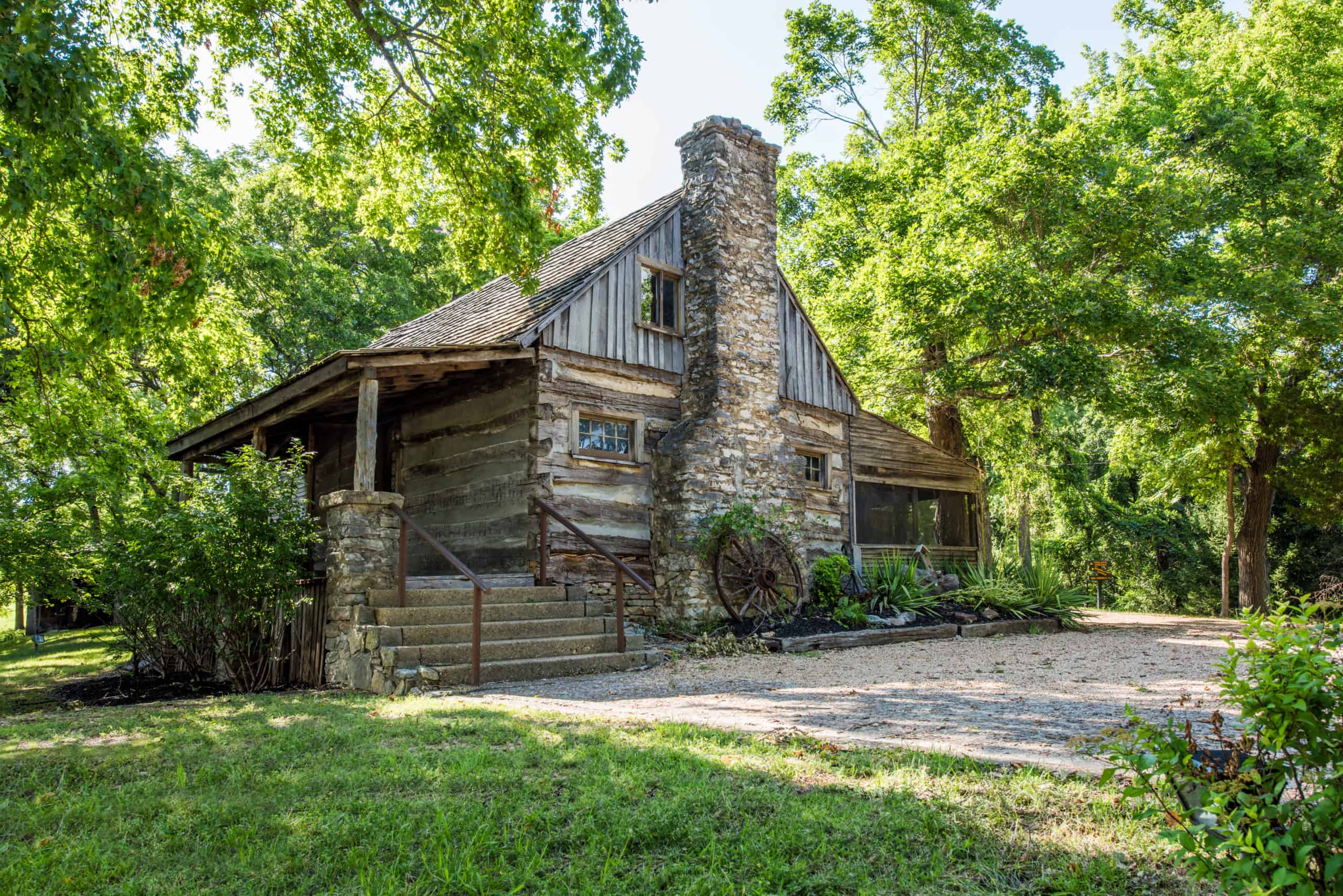 Old cabin surrounded by trees at The Shepherd of the Hills in Branson, Missouri.