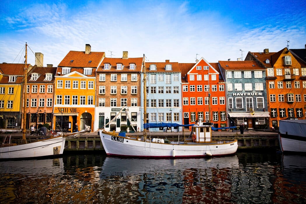 Colorful 17th-century buildings and boats in the lively Nyhavn harbor of Copenhagen.