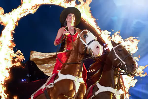 Woman riding a horse through a ring of fire at Dollar Patrons Dixie Stampede now called Dolly Parton's Stampede