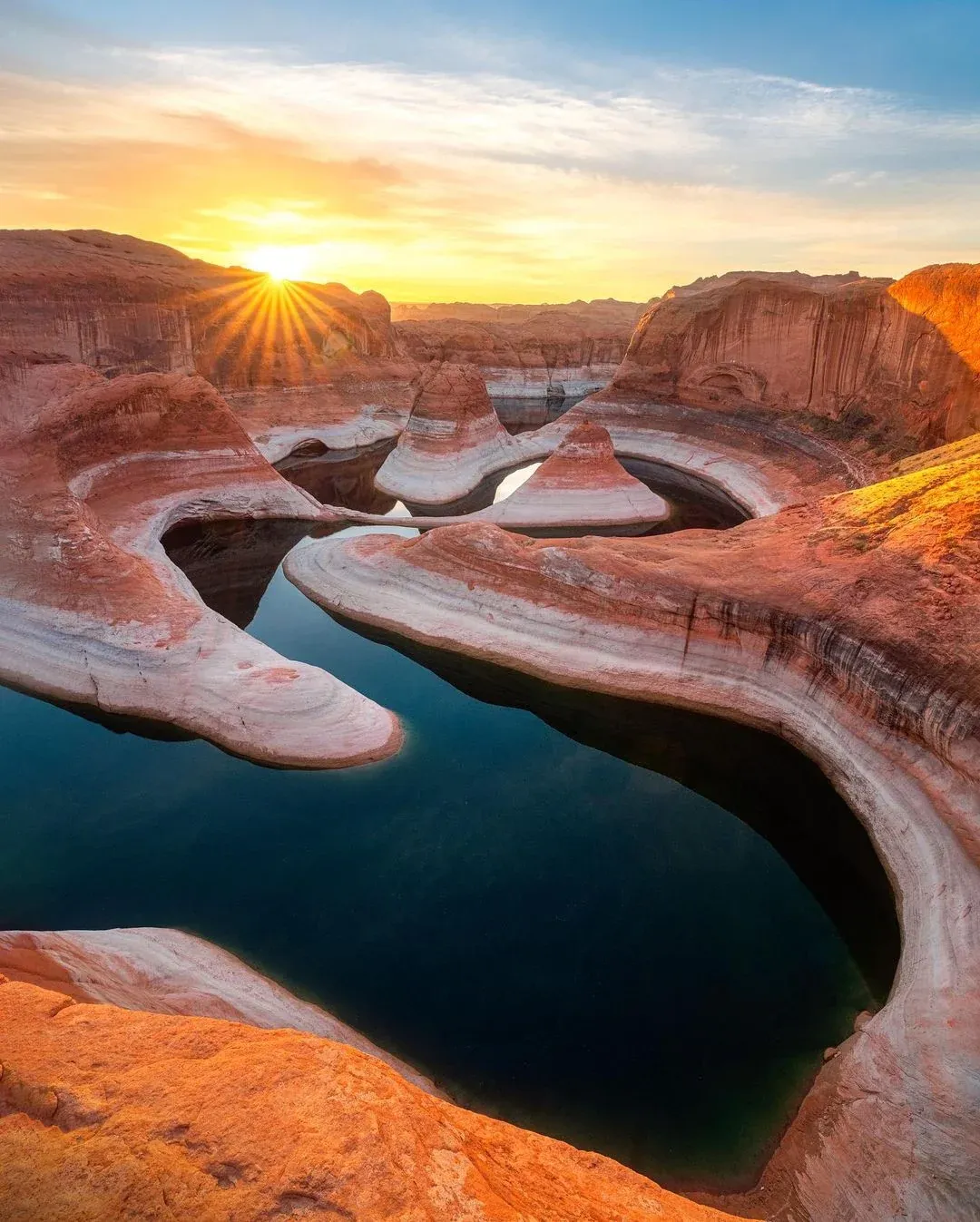 Sunrise over the sculpted red rock canyons and reflective waters of Lake Powell.Northern lights shimmer above the icy surface of Lake Baikal on a clear winter night.