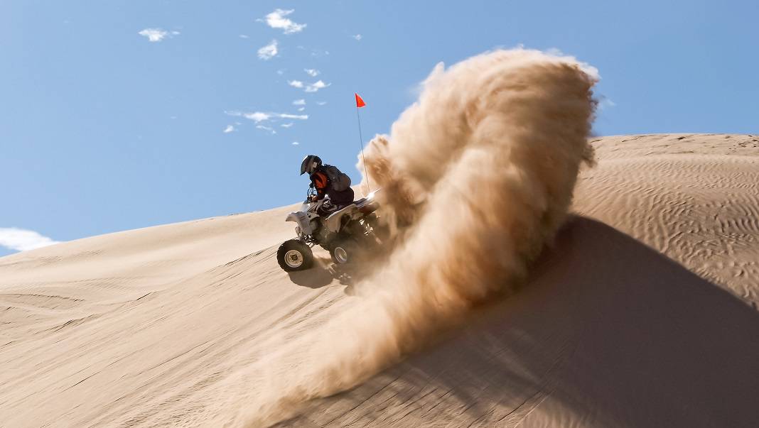 A person riding an ATV at Imperial Sand Dunes Recreation Area in Yuma Arizona.