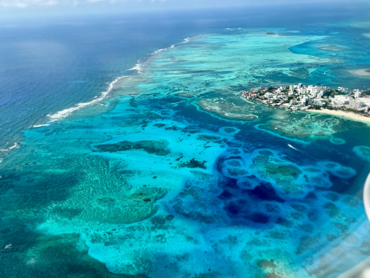 Aerial view of Providencia Island’s Sea of Seven Colors—shallow reefs and vibrant turquoise water surrounding the island.