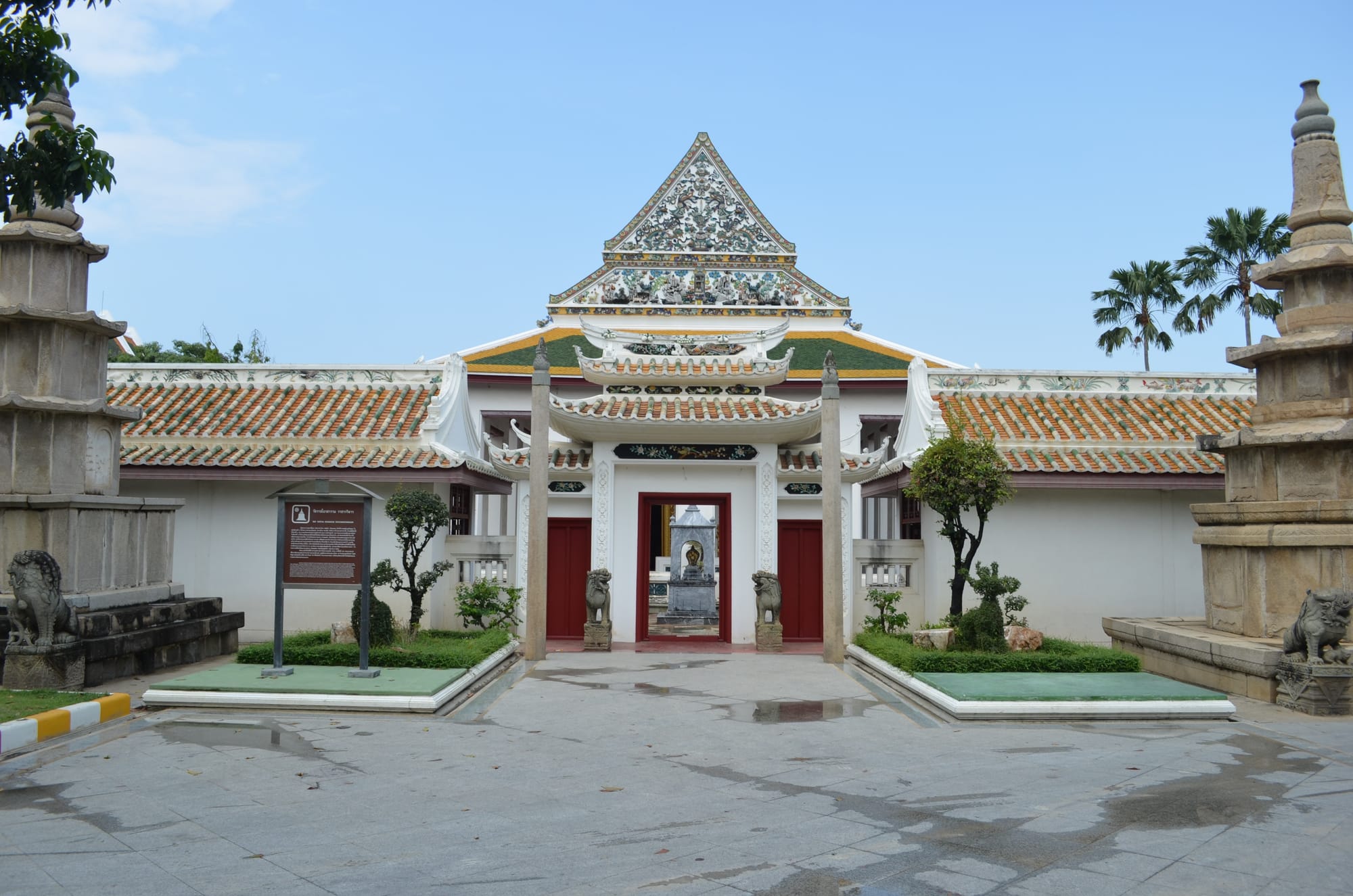 Front entrance of Wat Ratcha Orasaram Ratchaworawihan, a serene Buddhist temple in Bangkok, featuring traditional Thai architecture and manicured gardens.