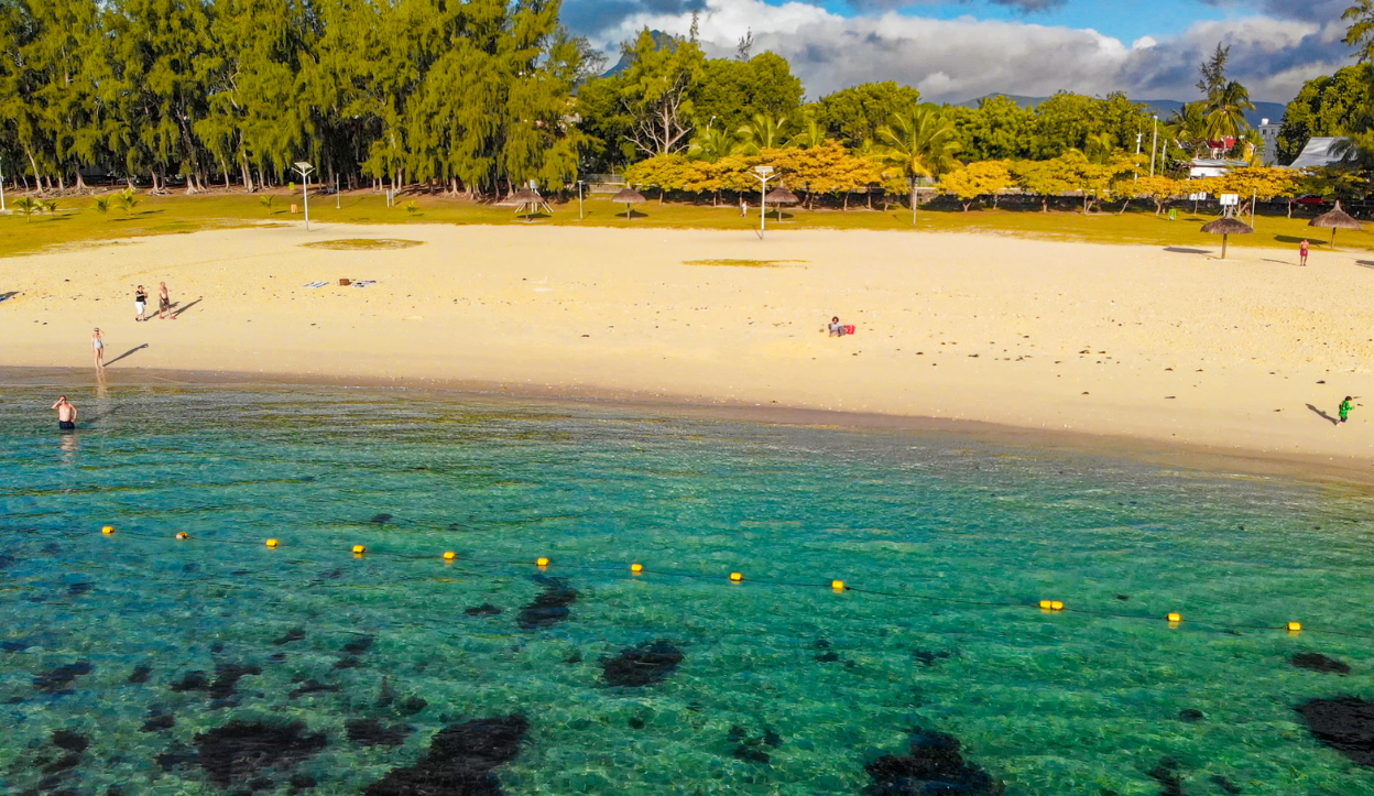 Flic en Flac Beach in Mauritius with floats to section off the swim section for visitors to the beach, and the waters is crystal clear waters.