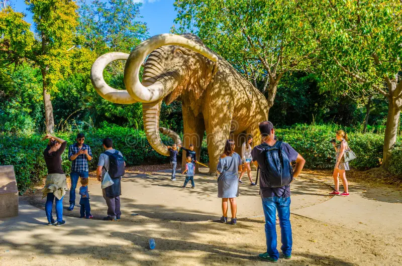 People looking at the Mammoth statue inside Barcelona's Park.