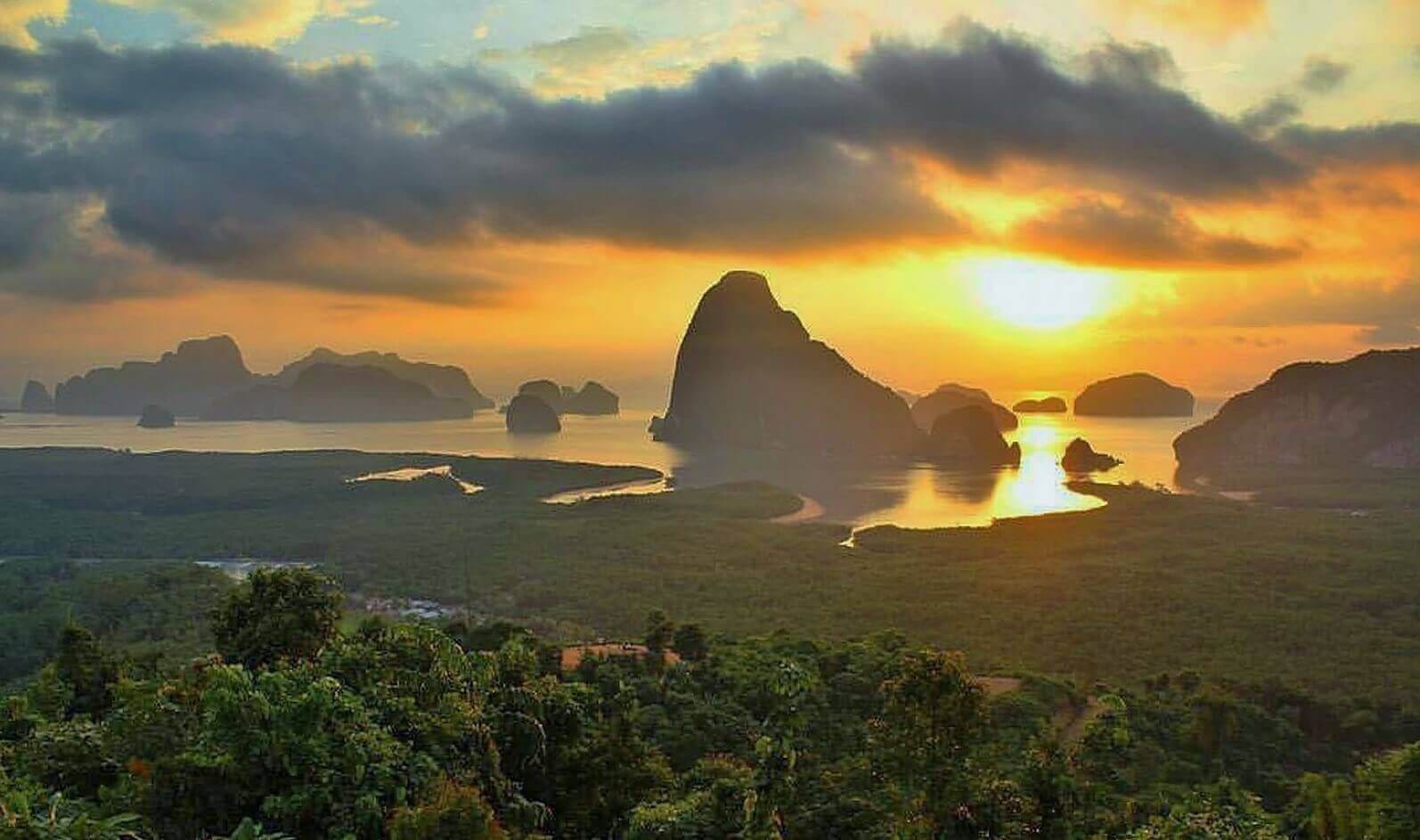 Sunrise over limestone karsts and water at Phang Nga Bay, Thailand.