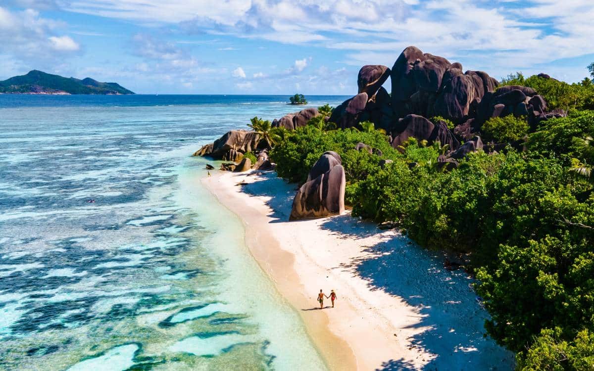 people walking on Anse Source d’Argent, La Digue