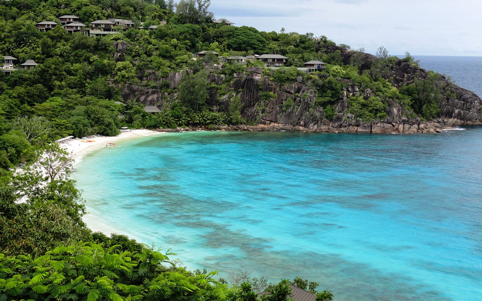 People hanging out on a beautiful beach of Petite Anse, La Digue