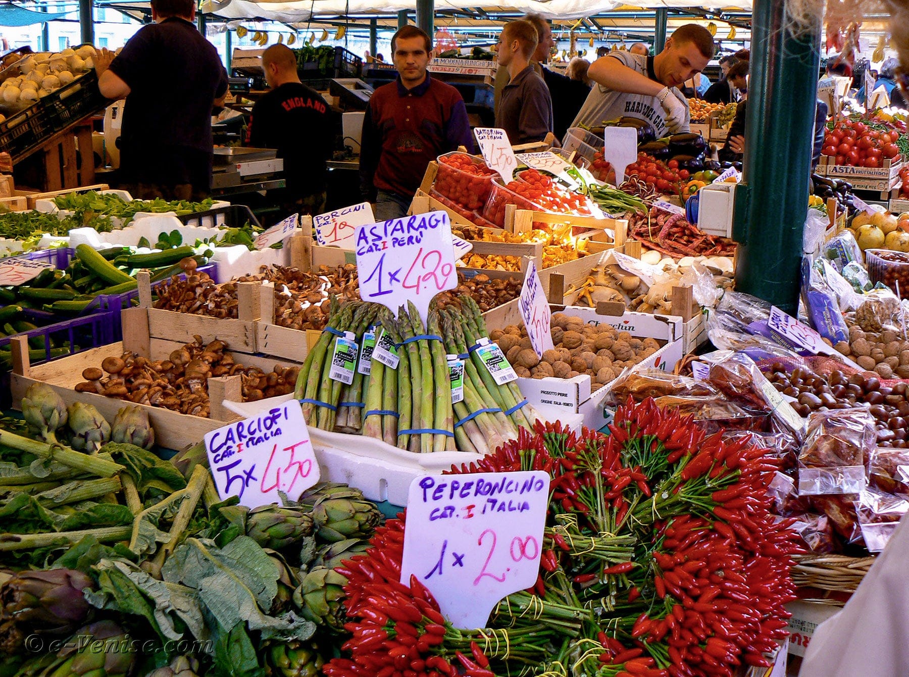 A fruit stand vendor with fresh produce for sale in Venice, Italy.