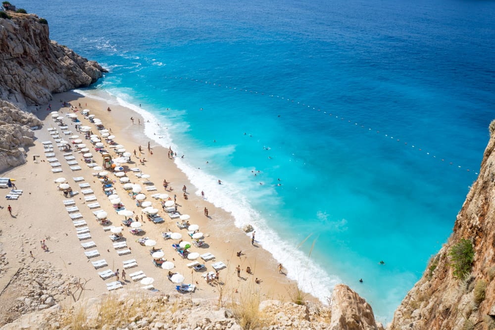 Kaputaş Beach, Kaş ariel view in Turkey with people enjoying a day at the beach.